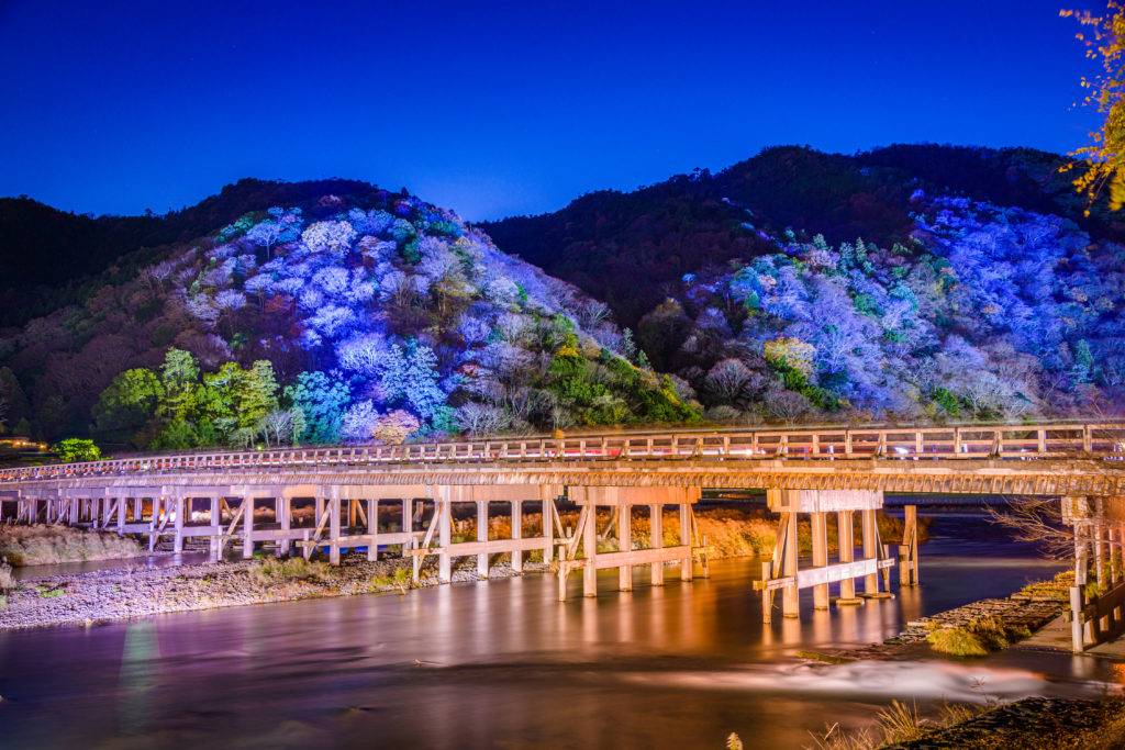 Arashiyama, Kyoto, Japan at Togetsukyo Bridge during the annual autumn light up.